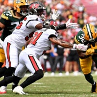 Oct 4, 2026; Tampa, Florida, USA; Tampa Bay Buccaneers safety Antoine Winfield Jr. (31) tackles Green Bay Packers running back MarShawn Lloyd (32) at Raymond James Stadium.