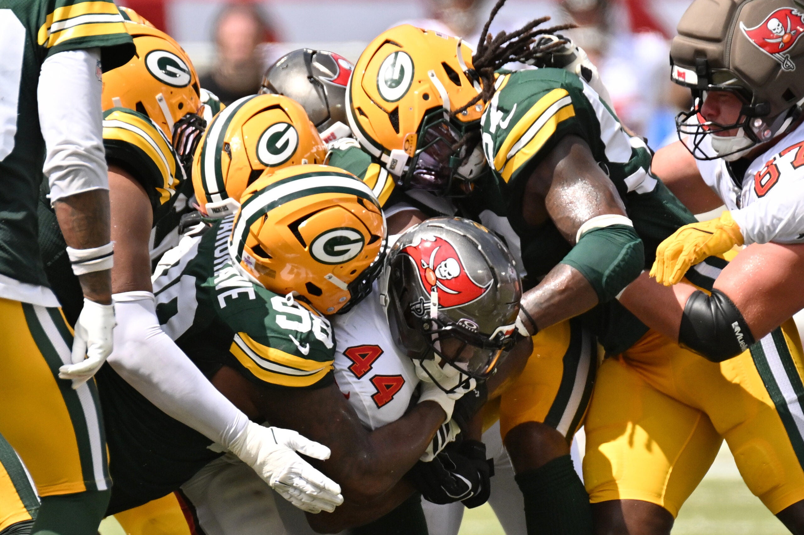 Oct 4, 2026; Tampa, Florida, USA; Green Bay Packers defensive tackle Javon Hargrave (98) tackles Tampa Bay Buccaneers running back Sean Tucker (44) during the game at Raymond James Stadium. Mandatory Credit: Jonathan Dyer-Imagn Images