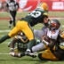 Oct 4, 2026; Tampa, Florida, USA; Green Bay Packers safety Evan Williams (33) and linebacker Edgerrin Cooper (56) tackles Tampa Bay Buccaneers quarterback Jalon Daniels (10) during the game at Raymond James Stadium.