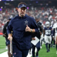 Oct 4, 2026; Houston, Texas, USA; Dallas Cowboys head coach Brian Schottenheimer runs off the field at halftime of a game against the Houston Texans at Reliant Stadium.