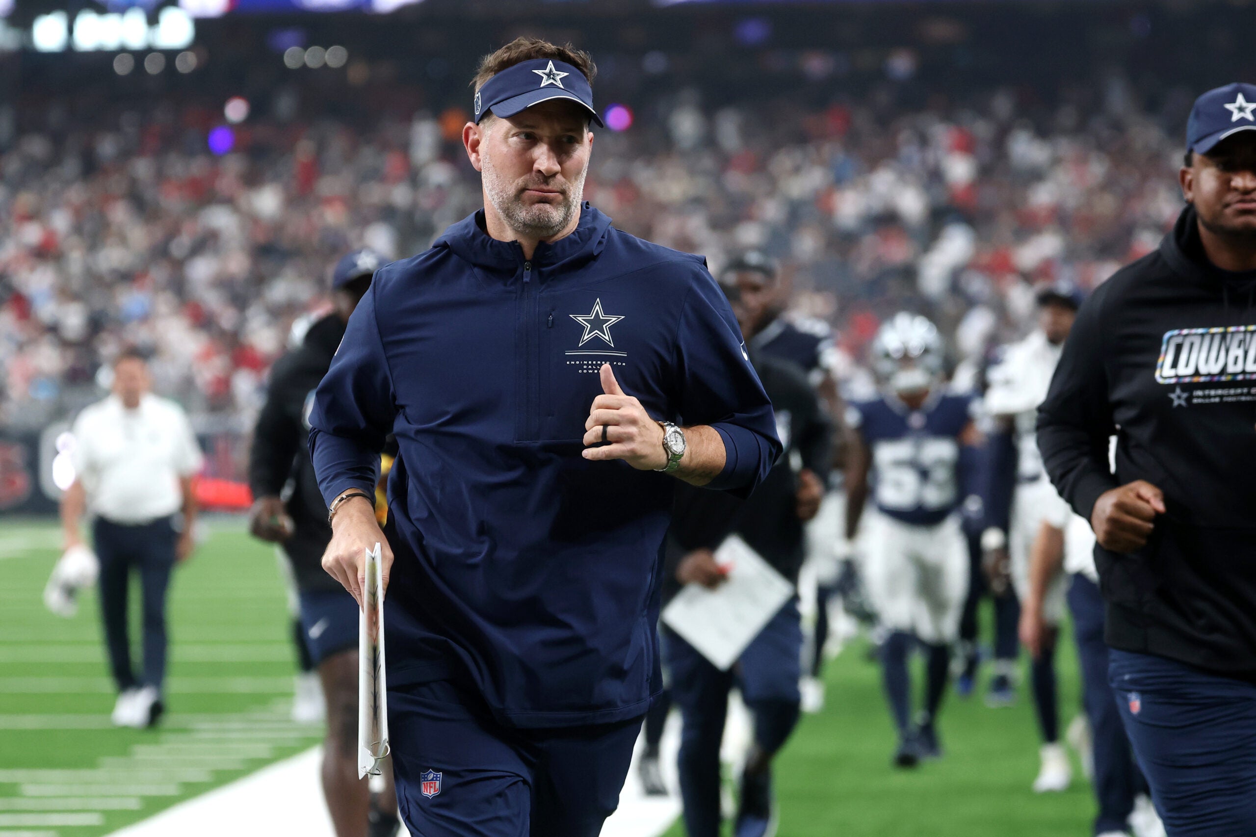 Oct 4, 2026; Houston, Texas, USA; Dallas Cowboys head coach Brian Schottenheimer runs off the field at halftime of a game against the Houston Texans at Reliant Stadium.