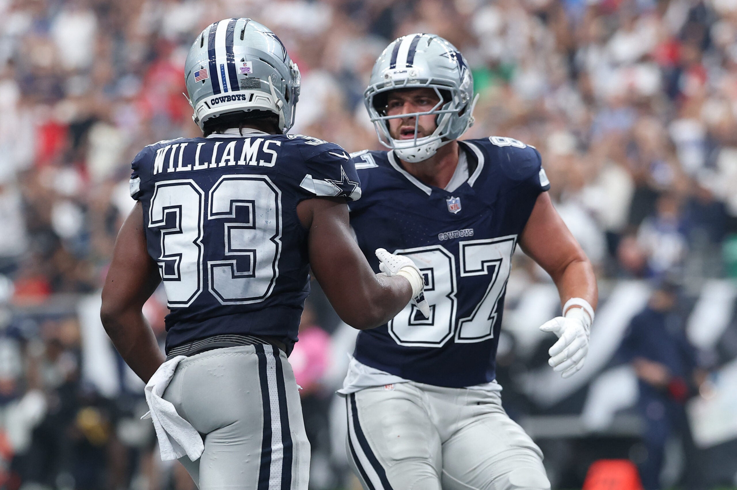 Oct 4, 2026; Houston, Texas, USA; Dallas Cowboys running back Javonte Williams (33) reacts with tight end Jake Ferguson (87) after scoring a touchdown against the Houston Texans during the second half at Reliant Stadium.