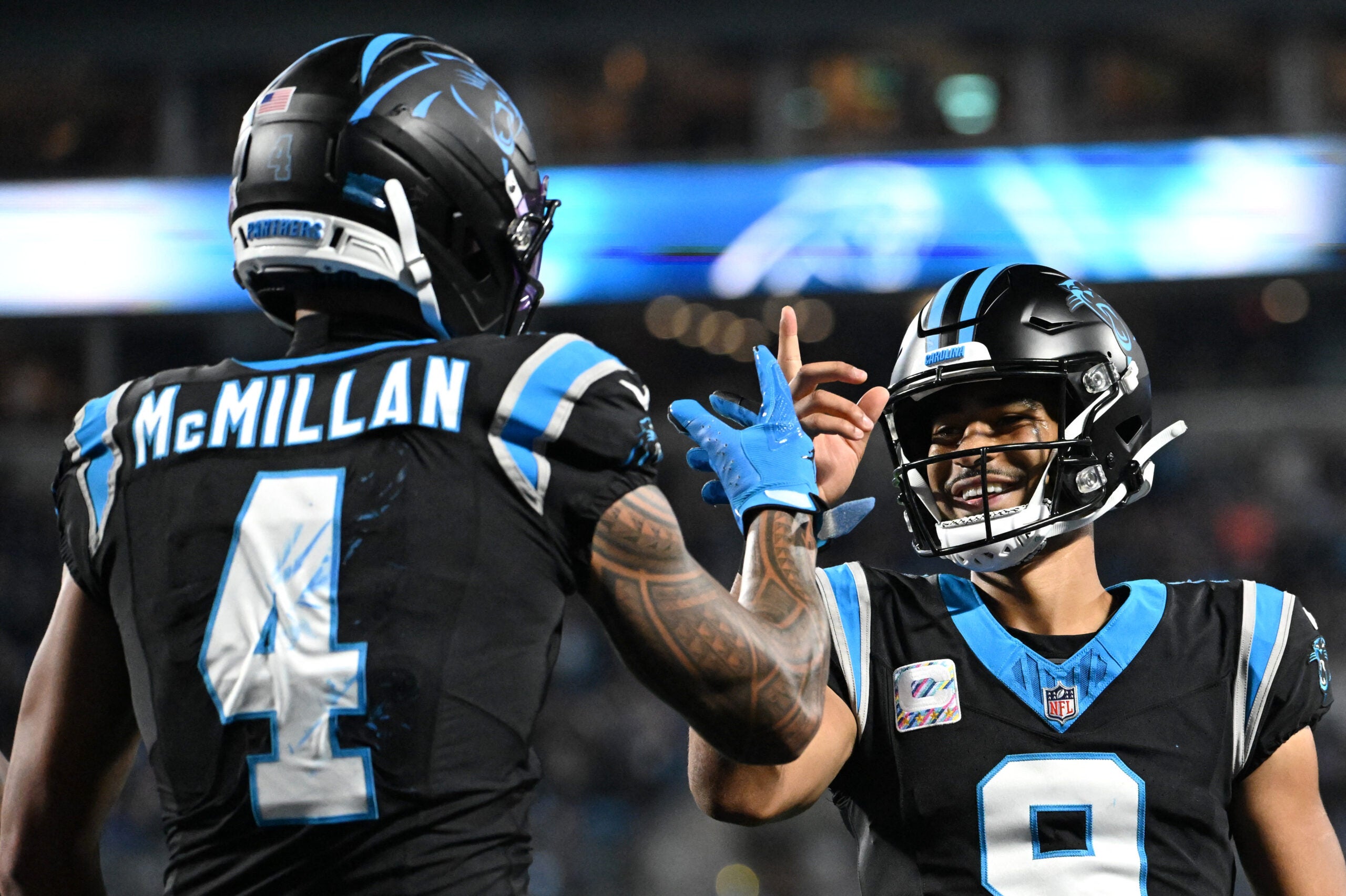Oct 4, 2026; Charlotte, North Carolina, USA; Carolina Panthers wide receiver Tetairoa McMillan (4) celebrates with quarterback Bryce Young (9) after scoring a touchdown against the Detroit Lions during the third quarter at Bank of America Stadium.