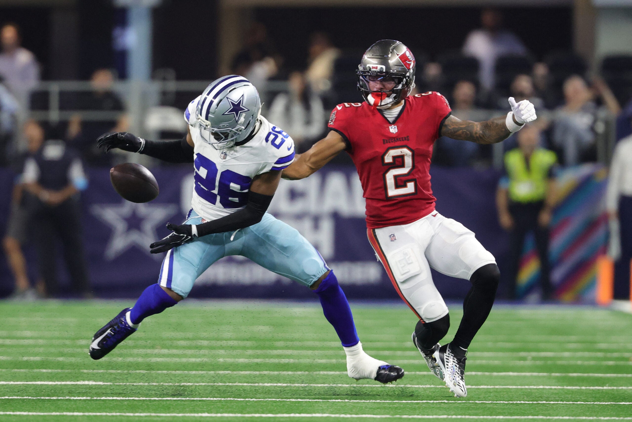 Oct 8, 2026; Arlington, Texas, USA; Dallas Cowboys cornerback DaRon Bland (26) attempts to make an interception against Tampa Bay Buccaneers wide receiver Emeka Egbuka (2) at AT&T Stadium.