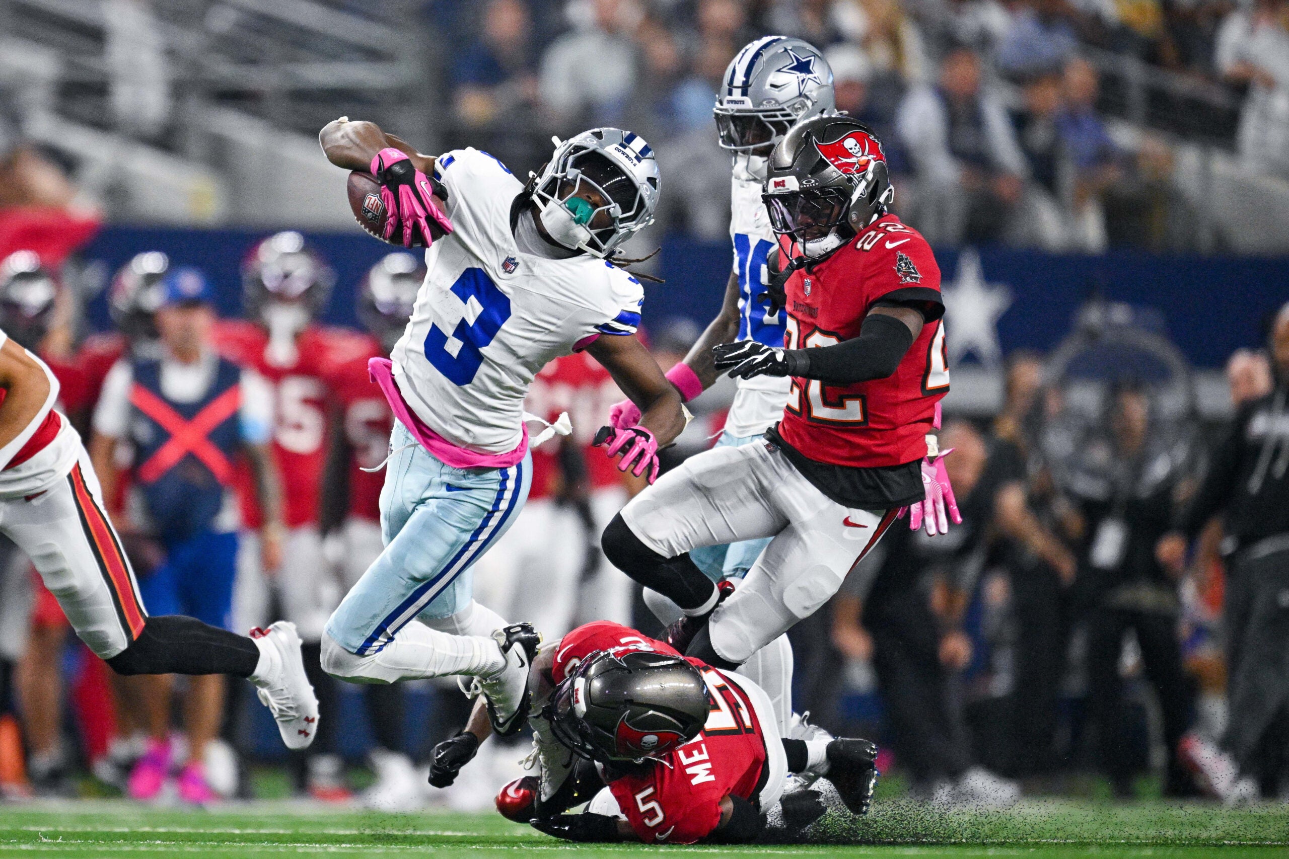 Oct 8, 2026; Arlington, Texas, USA; Tampa Bay Buccaneers cornerback Keionte Scott (22) and safety Ifeatu Melifonwu (5) tackle Dallas Cowboys wide receiver George Pickens (3) during the game between the Cowboys and the Buccaneers at AT&T Stadium.