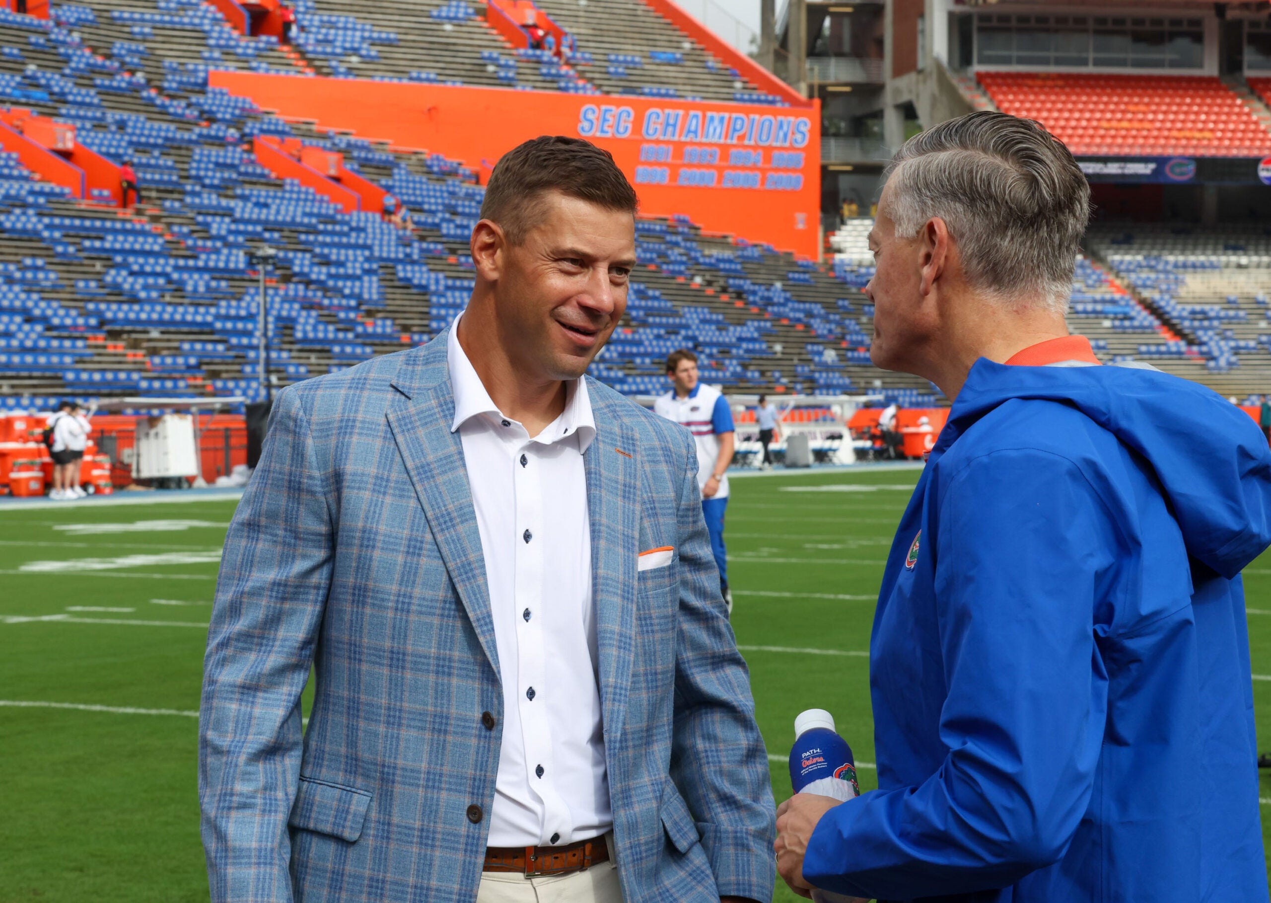 Florida head coach Jon Sumrall, left, talks with UF Athletic Director Scott Stricklin during Gator Walk before an NCAA football at Steve Spurrier Field at Ben Hill Griffin Stadium in Gainesville, FL on Saturday, October 10, 2026.