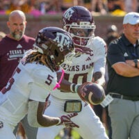 Oct 10, 2026; Columbia, Missouri, USA; Texas A&M Aggies quarterback Marcel Reed (10) hands off to running back Carsyn Baker (5) against the Missouri Tigers prior to a game at Faurot Field at Memorial Stadium.