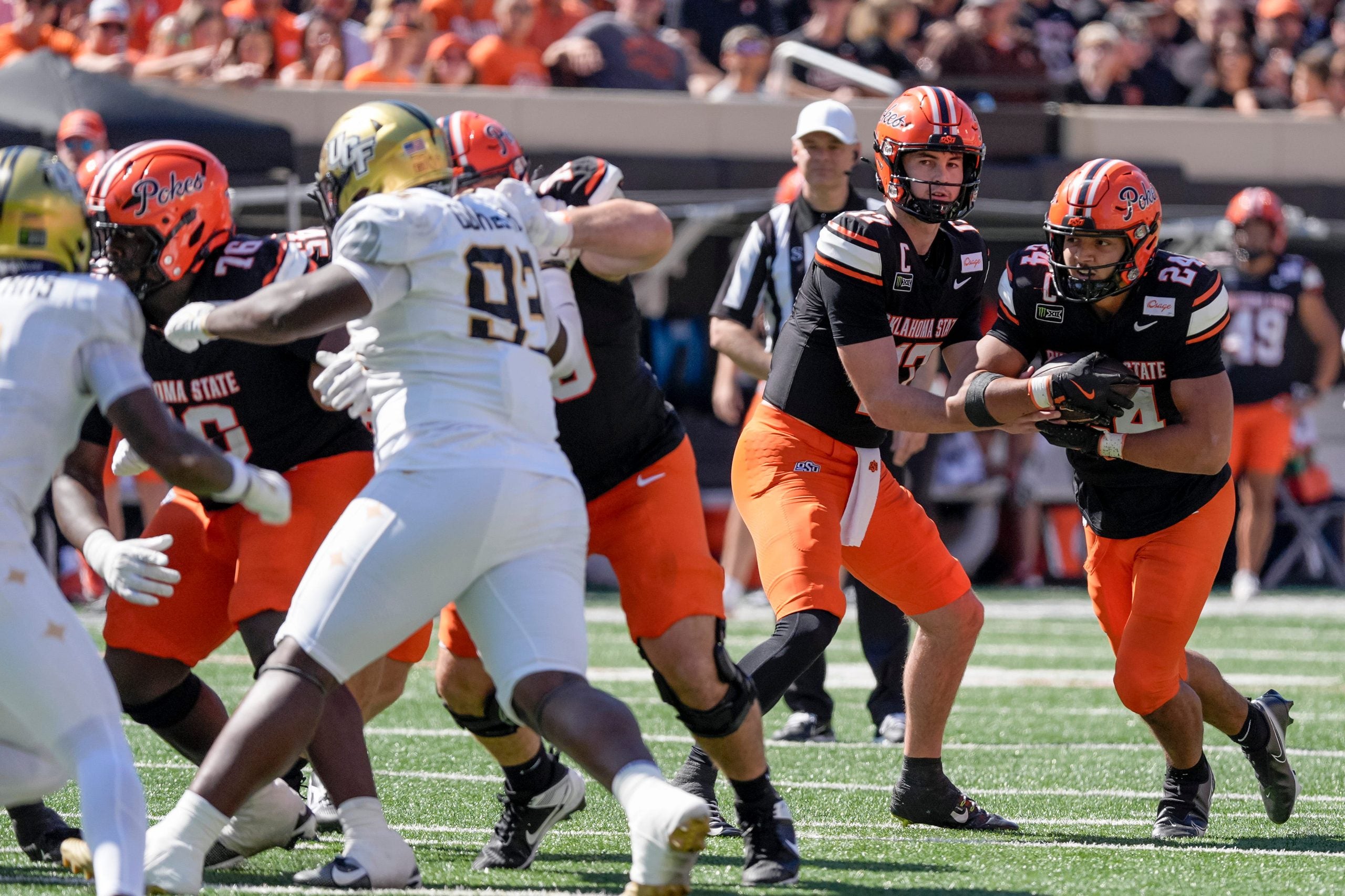 OSU quarterback Drew Mestemaker (17) hands off the ball to OSU running back Caleb Hawkins (24) in the third quarter during an NCAA football game between the Oklahoma State University (OSU) Cowboys and the University of Central Florida (UCF) Knights at Boone Pickens Stadium in Stillwater, Okla., on Saturday, Oct. 10, 2026.