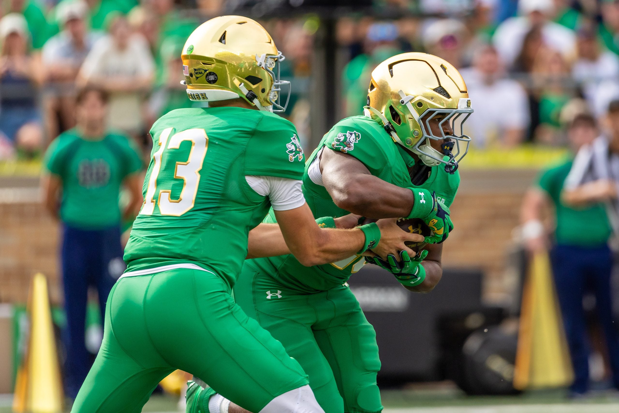 Oct 10, 2026; South Bend, Indiana, USA; Notre Dame Fighting Irish quarterback CJ Carr (13) hands off to running back Jonaz Walton (20) against the Stanford Cardinal during the first half at Notre Dame Stadium.