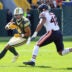 Oct 11, 2026; Green Bay, Wisconsin, USA; Green Bay Packers wide receiver Christian Watson (9) carries the ball defended by Chicago Bears linebacker D'Marco Jackson (48) during the first quarter at Lambeau Field.