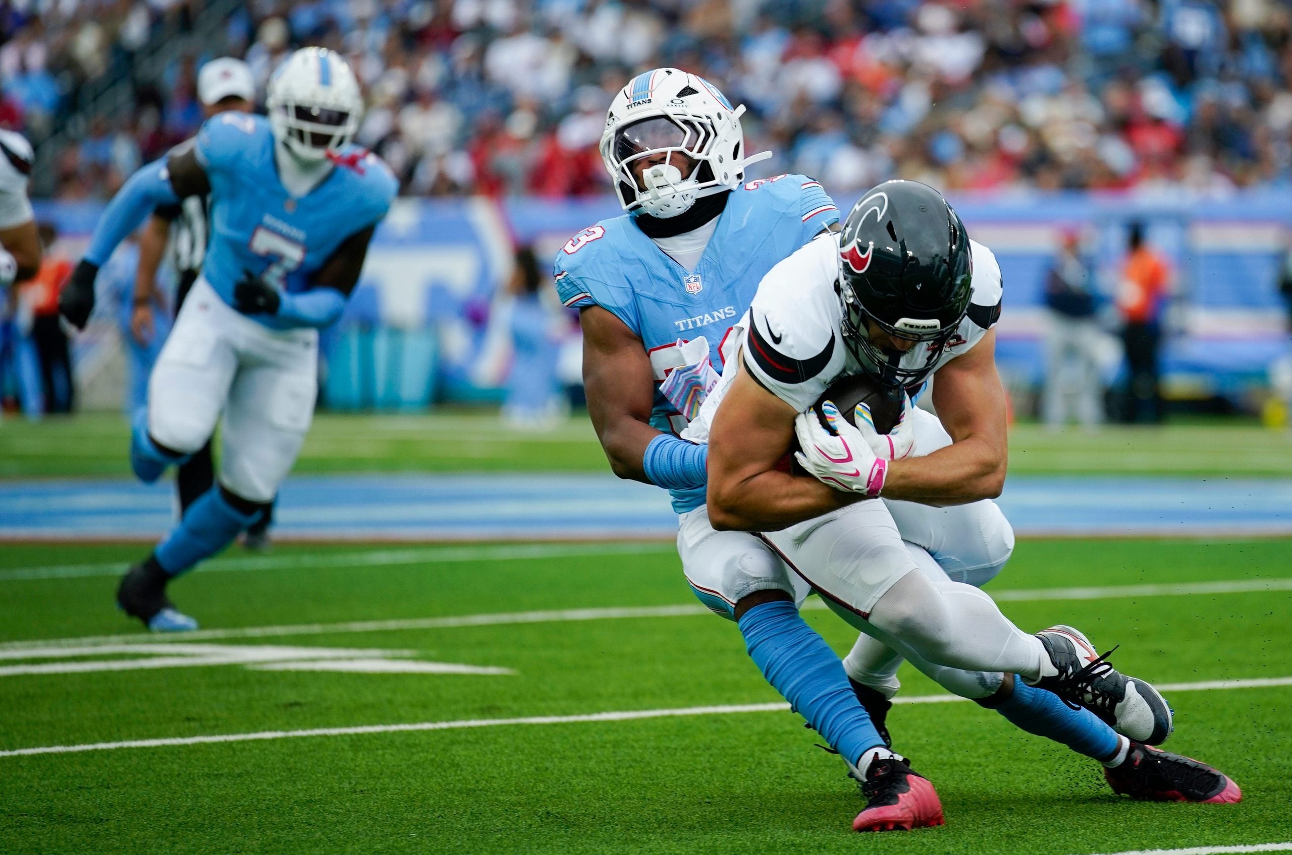 Tennessee Titans linebacker Cedric Gray (33) brings down Houston Texans tight end Foster Moreau (87) during the second quarter at Nissan Stadium in Nashville, Tenn., Sunday, Oct. 11, 2026.