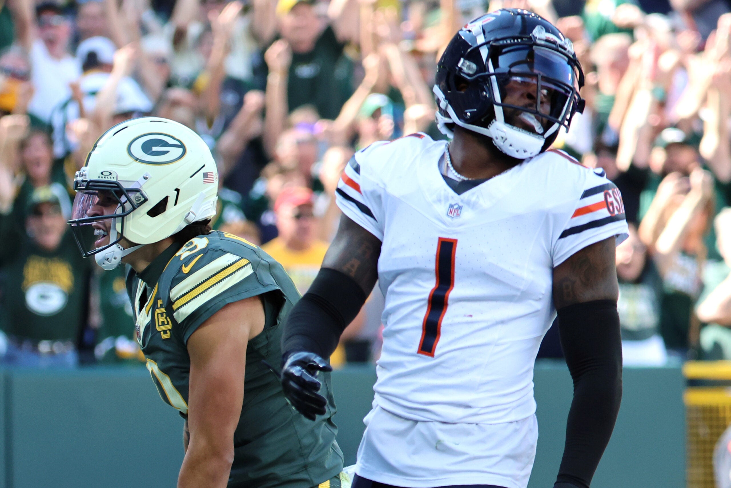 Oct 11, 2026; Green Bay, Wisconsin, USA; Green Bay Packers wide receiver Christian Watson (9) celebrates after scoring a touchdown as Chicago Bears defensive back Jaylon Johnson (1) reacts during the third quarter at Lambeau Field.