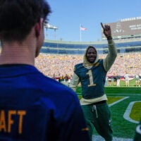 Green Bay Packers edge defender Micah Parsons (1) interacts with fans before a game against the Chicago Bears on Sunday, Oct. 11, 2026, at Lambeau Field in Green Bay, Wisconsin. The Packers won the game, 31-7.