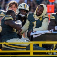 Green Bay Packers defensive end Micah Parsons (1) checks on defensive tackle Javon Hargrave (98) as Hargrave is carted off the field with an injury against the Chicago Bears on Sunday, Oct. 11, 2026, at Lambeau Field in Green Bay, Wisconsin. The Packers won the game, 31-7.