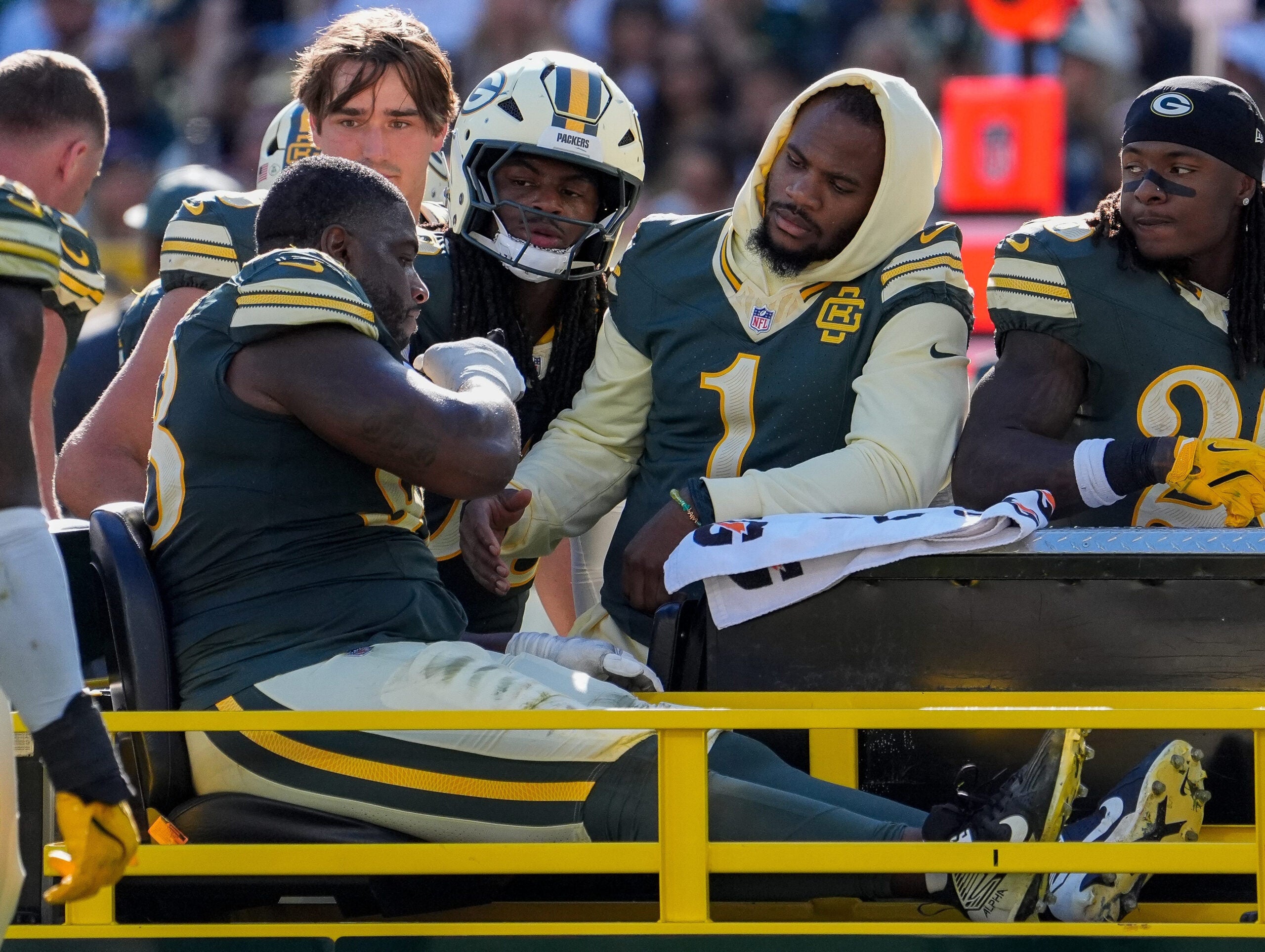 Green Bay Packers defensive end Micah Parsons (1) checks on defensive tackle Javon Hargrave (98) as Hargrave is carted off the field with an injury against the Chicago Bears on Sunday, Oct. 11, 2026, at Lambeau Field in Green Bay, Wisconsin. The Packers won the game, 31-7.