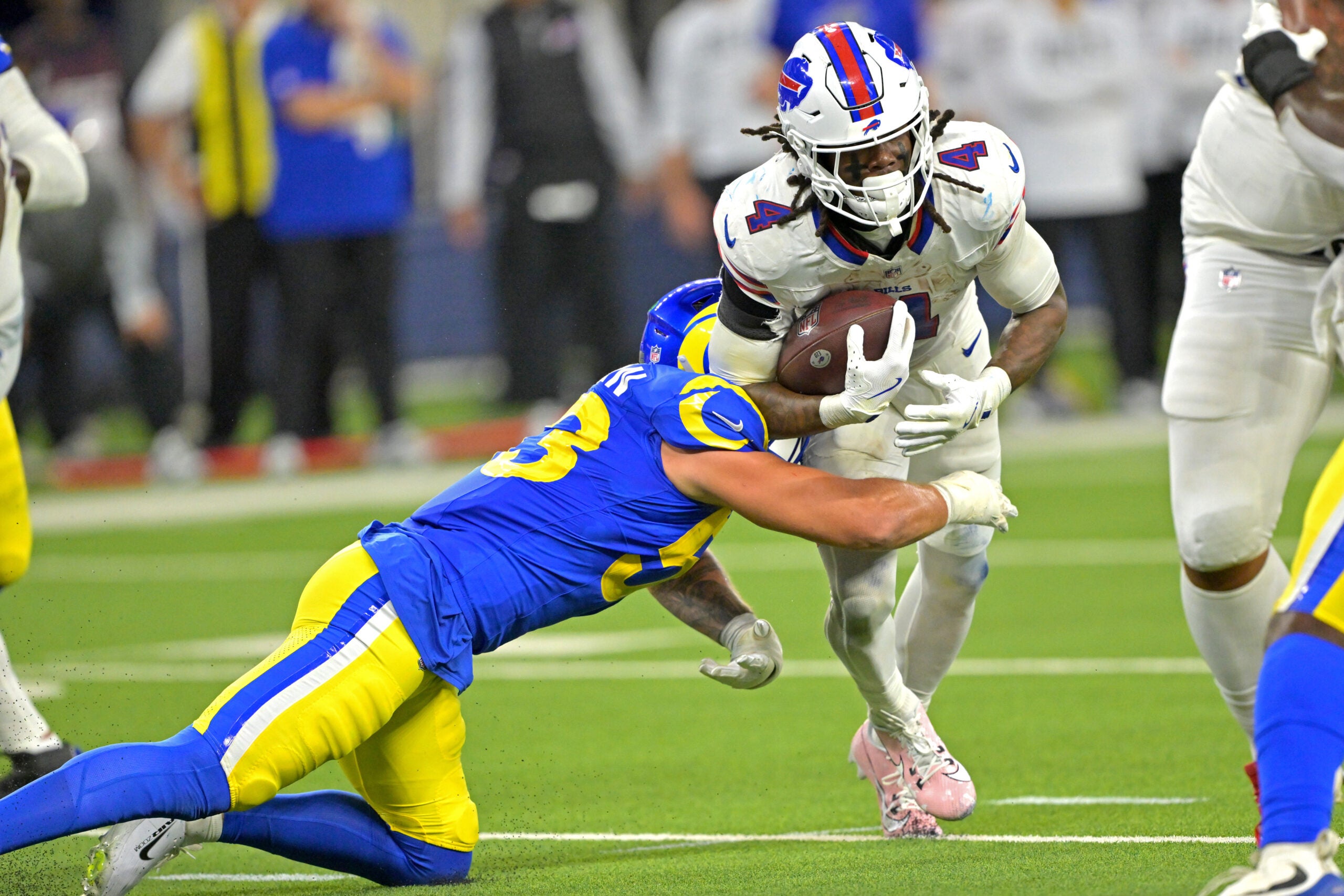Oct 12, 2026; Inglewood, California, USA; Los Angeles Rams linebacker Nate Landman (53) forces a fumble by Buffalo Bills running back James Cook III (4) during the third quarter at SoFi Stadium.