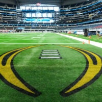The College Football Playoff logo is painted in the endzone prior to the Cotton Bowl between the Ohio State Buckeyes and the Miami Hurricanes at AT&T Stadium in Arlington, Texas on Dec. 31, 2025.
