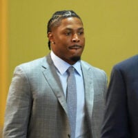 Green Bay Packers running back Josh Jacobs, right, appears in a Brown County courtroom on Sept. 10, 2026 in Green Bay, Wis., with his attorney Clarence Duchac III.