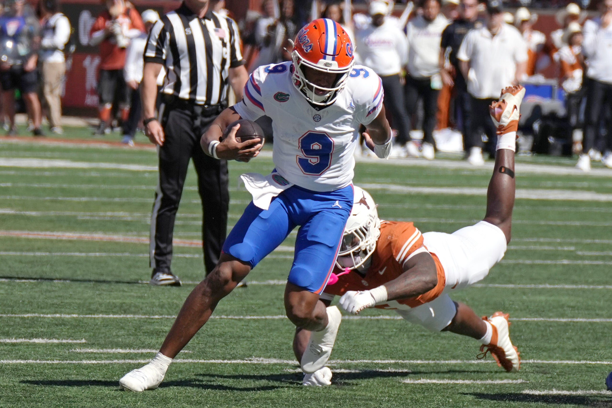 Oct 17, 2026; Austin, Texas, USA; Florida Gators quarterback Tramell Jones Jr. (9) escapes a tackle from Texas Longhorns linebacker Rasheem Biles (3) during the first half at Darrell K Royal-Texas Memorial Stadium.