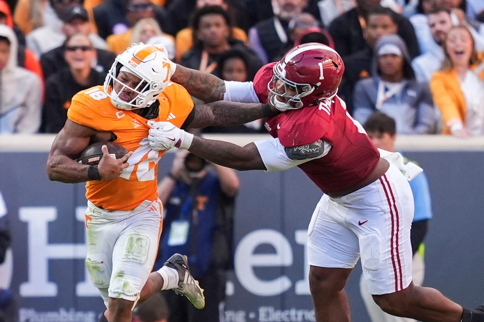 Alabama defensive lineman Devan Thompkins (1) holds onto Tennessee running back DeSean Bishop (18) during a football game between Tennessee and Alabama at Neyland Stadium in Knoxville, Tenn., on Oct. 17, 2026.