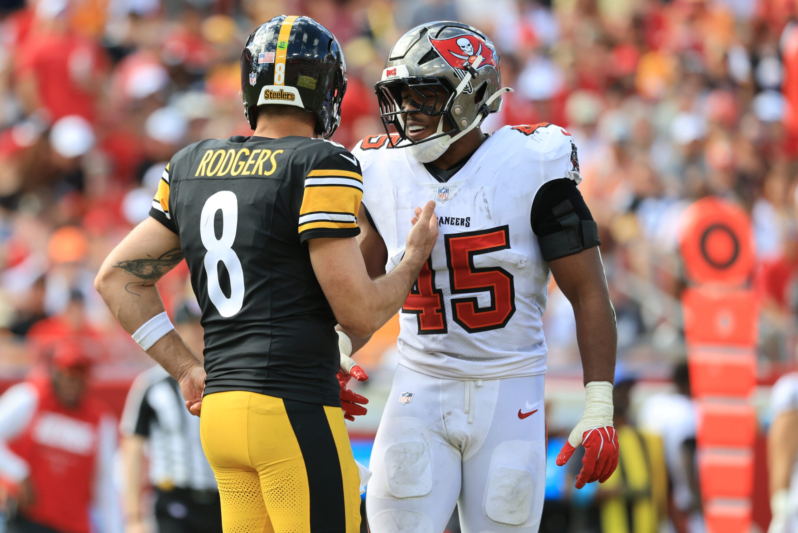 Oct 18, 2026; Tampa, Florida, USA; Pittsburgh Steelers quarterback Aaron Rodgers (8) speaks with Tampa Bay Buccaneers linebacker Josiah Trotter (45) during the third quarter at Raymond James Stadium.