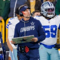 Oct 18, 2026; Green Bay, Wisconsin, USA; Dallas Cowboys head coach Brian Schottenheimer watches the field alongside Dallas Cowboys Tyrus Wheat (59) at Lambeau Field.