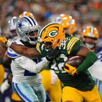 Oct 18, 2026; Green Bay, Wisconsin, USA; Green Bay Packers running back MarShawn Lloyd (32) runs the ball against Dallas Cowboys cornerback DaRon Bland (26) during the during the first quarter at Lambeau Field.
