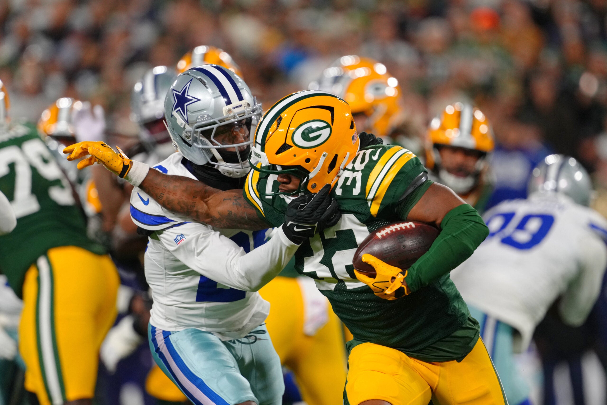 Oct 18, 2026; Green Bay, Wisconsin, USA; Green Bay Packers running back MarShawn Lloyd (32) runs the ball against Dallas Cowboys cornerback DaRon Bland (26) during the during the first quarter at Lambeau Field.