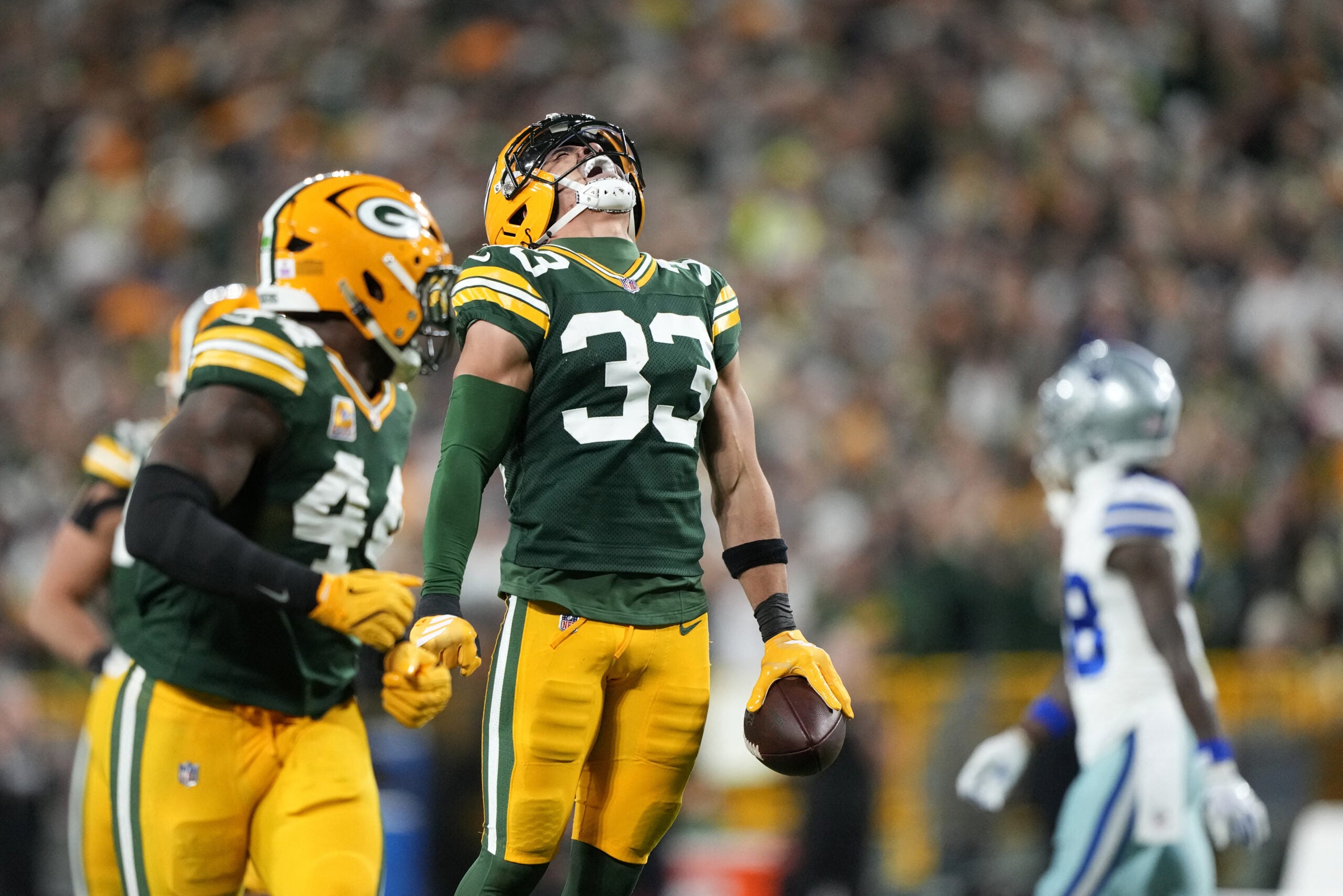 Oct 18, 2026; Green Bay, Wisconsin, USA; Green Bay Packers safety Evan Williams (33) celebrates after making an interception against the Dallas Cowboys during the second quarter at Lambeau Field.