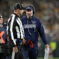 Oct 18, 2026; Green Bay, Wisconsin, USA; Dallas Cowboys head coach Brian Schottenheimer talks with an official during the first half of the game against the Green Bay Packers at Lambeau Field.