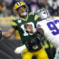 Dallas Cowboys defensive tackle Kenny Clark (97) sacks Green Bay Packers quarterback Jordan Love (10) during the third quarter of their game Sunday, Oct. 18, 2026 at Lambeau Field in Green Bay, Wisconsin.