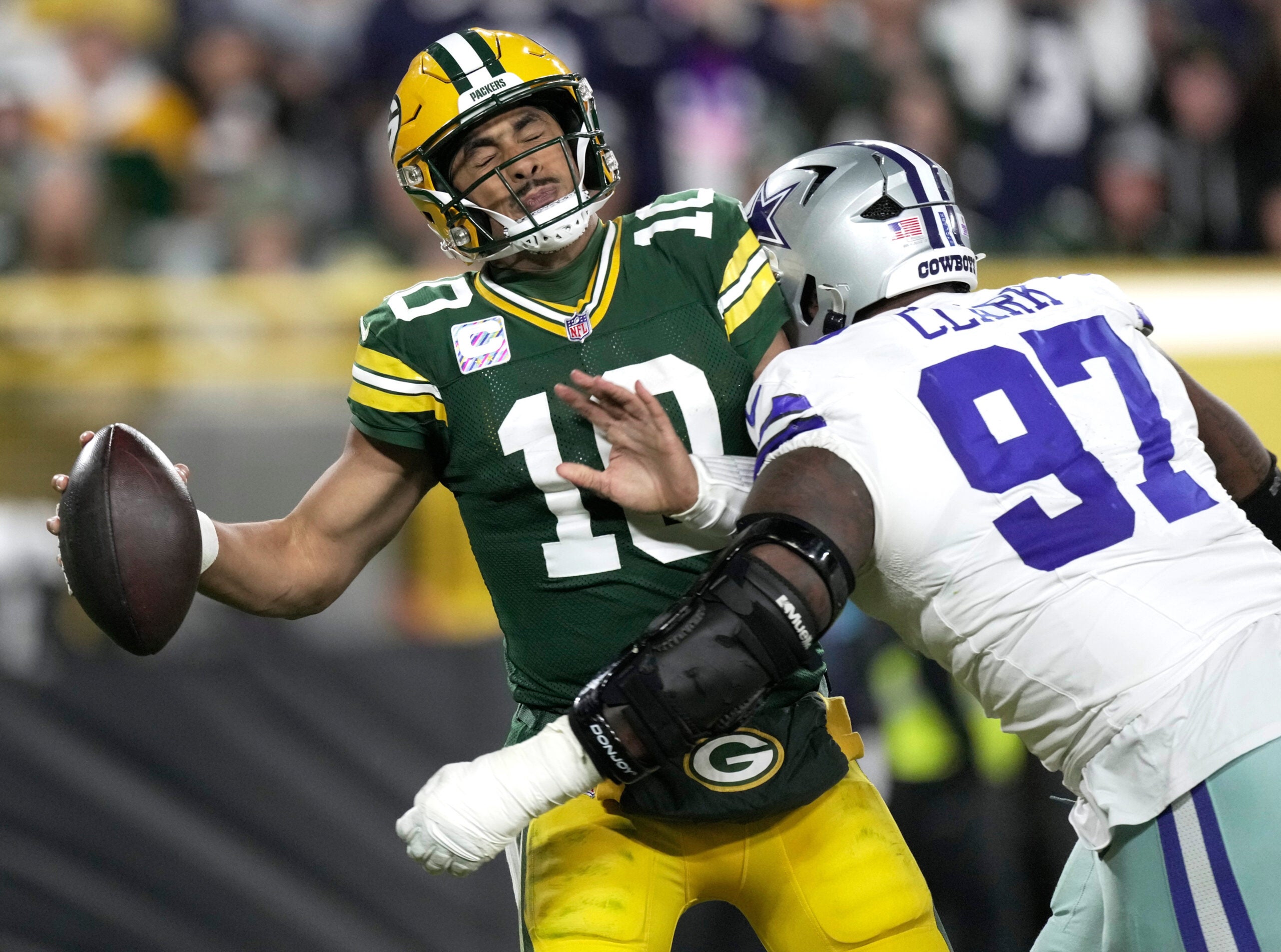 Dallas Cowboys defensive tackle Kenny Clark (97) sacks Green Bay Packers quarterback Jordan Love (10) during the third quarter of their game Sunday, Oct. 18, 2026 at Lambeau Field in Green Bay, Wisconsin.