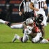 Oct 22, 2026; Chicago, Illinois, USA; New England Patriots running back Treveyon Henderson (32) is tackled by Chicago Bears defensive end Jamree Kromah (59) during the second half at Soldier Field.
