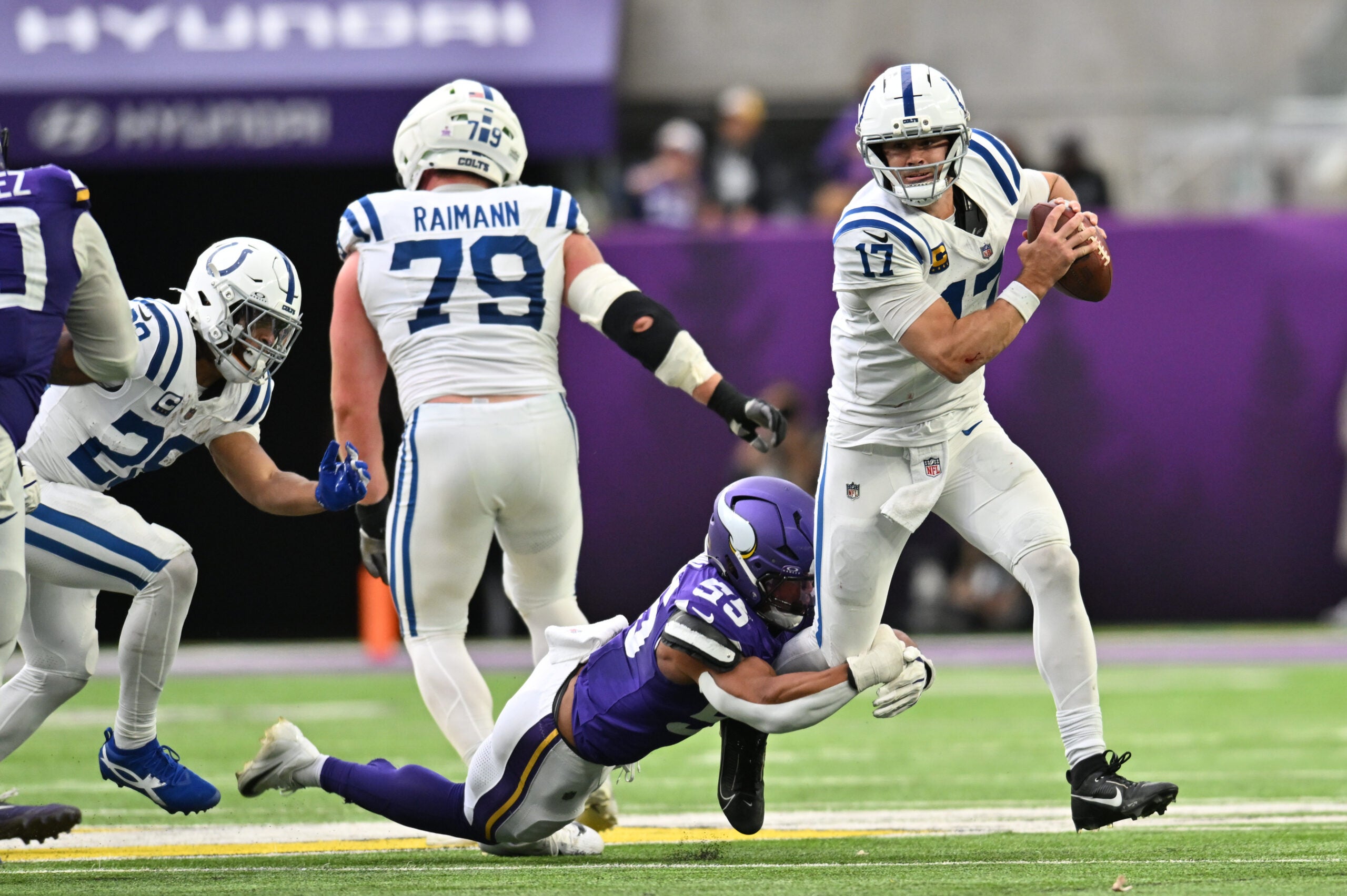 Oct 25, 2026; Minneapolis, Minnesota, USA; Indianapolis Colts quarterback Daniel Jones (17) avoids the tackle of Minnesota Vikings linebacker Eric Wilson (55) at U.S. Bank Stadium.