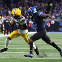 Oct 25, 2026; Detroit, Michigan, USA; Green Bay Packers wide receiver Savion Williams (83) runs the ball against Detroit Lions cornerback Ennis Rakestraw Jr. (2) during the first quarter at Ford Field.
