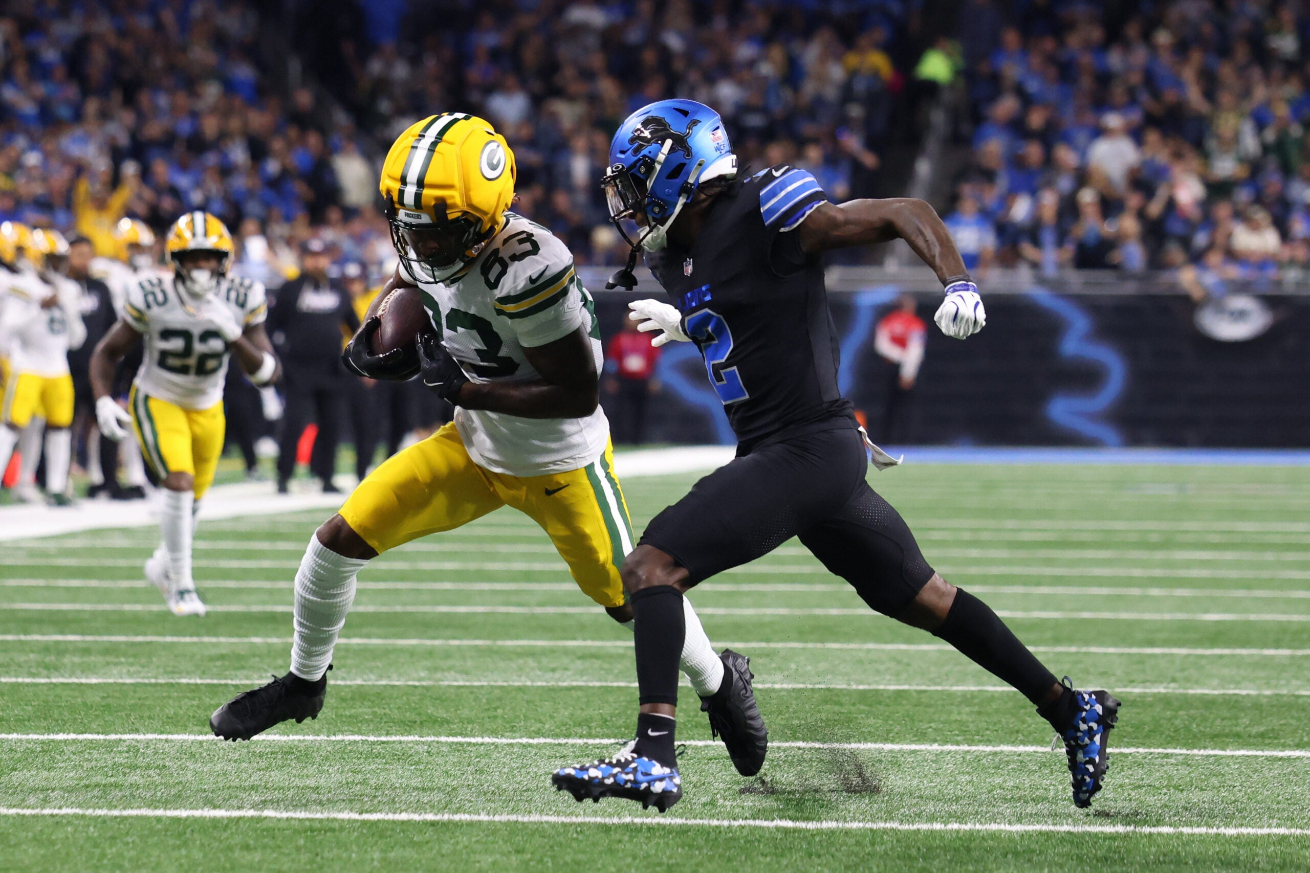 Oct 25, 2026; Detroit, Michigan, USA; Green Bay Packers wide receiver Savion Williams (83) runs the ball against Detroit Lions cornerback Ennis Rakestraw Jr. (2) during the first quarter at Ford Field.