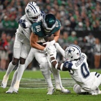 Oct 26, 2026; Philadelphia, Pennsylvania, USA; Philadelphia Eagles tight end Dallas Goedert (88) is tackled by Dallas Cowboys cornerback Joey Porter Jr. (25) and linebacker DeMarvion Overshown (0) during the first half at Lincoln Financial Field.