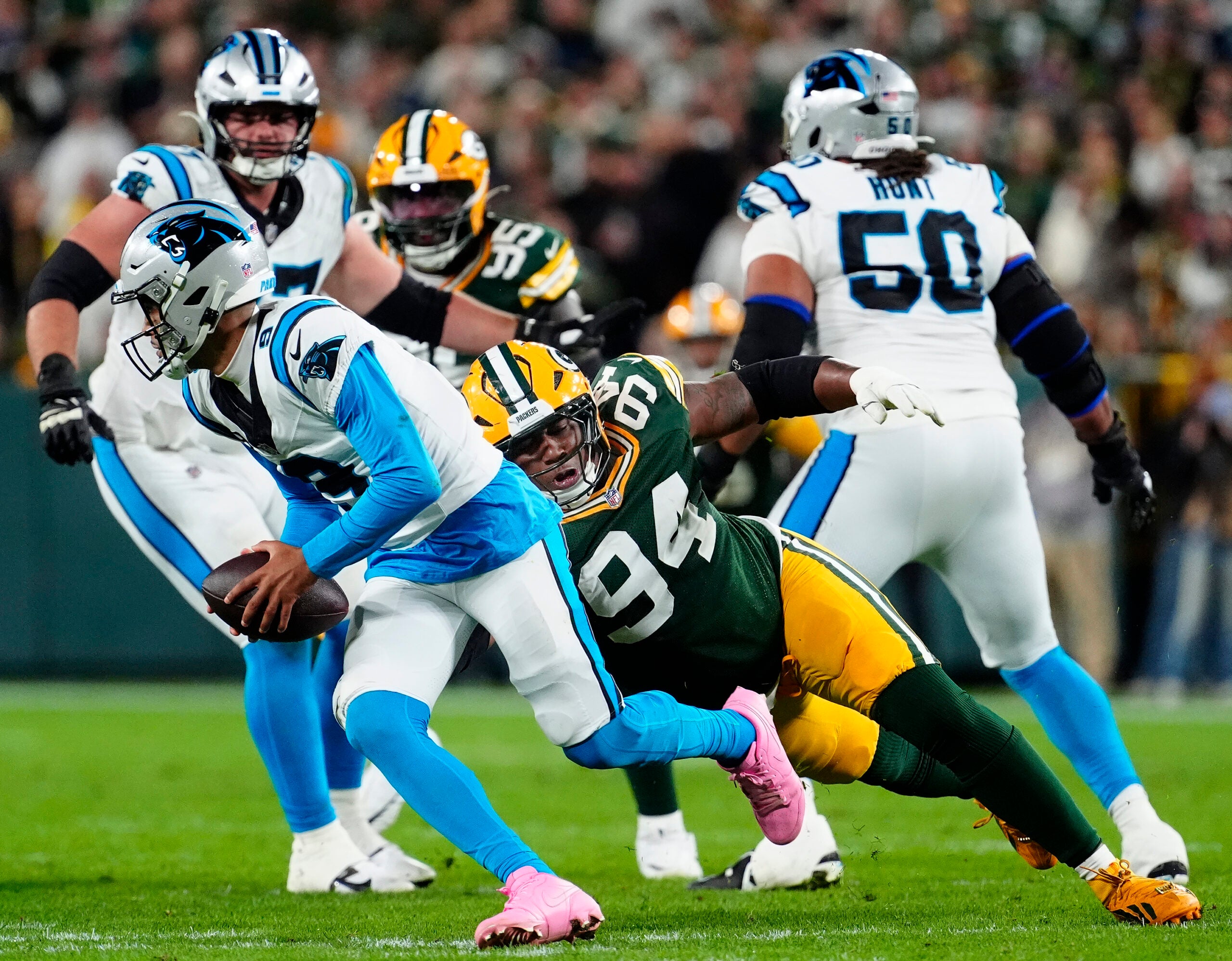 Oct 29, 2026; Green Bay, Wisconsin, USA; Green Bay Packers defensive tackle Karl Brooks (94) pressures Carolina Panthers quarterback Bryce Young (9) during their football game at Lambeau Field.