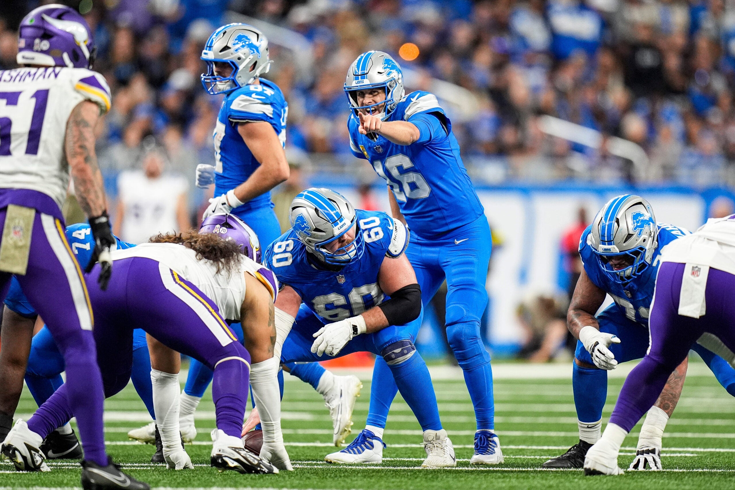 Detroit Lions quarterback Jared Goff (16) talks to center Graham Glasgow (60) before a play against Minnesota Vikings during the second half at Ford Field in Detroit on Sunday, November 2, 2025.