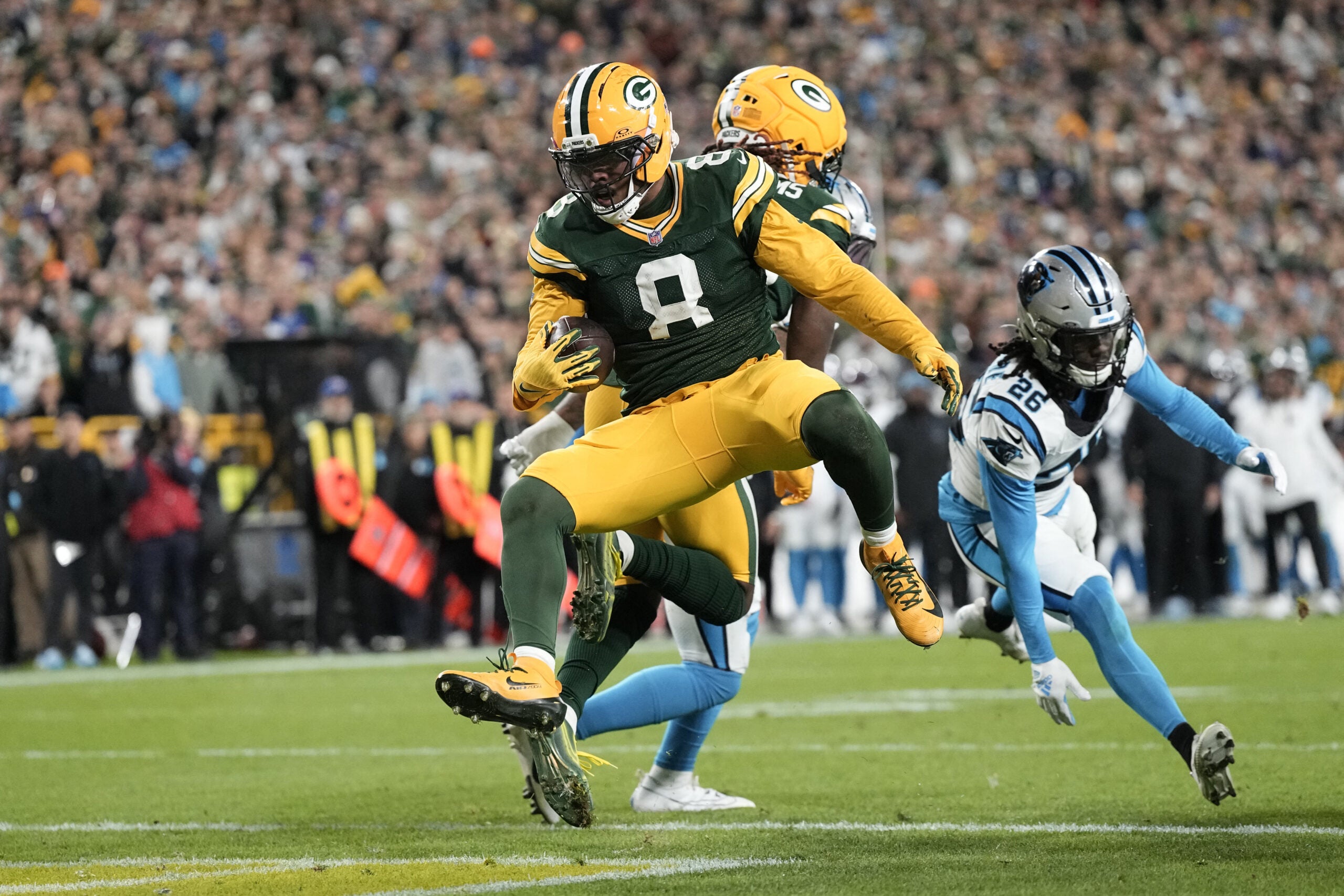 Oct 29, 2026; Green Bay, Wisconsin, USA; Green Bay Packers running back Josh Jacobs (8) rushes for a touchdown against the Carolina Panthers in the first half at Lambeau Field.